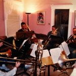 photo of Matthew McGarrell with friends all playing trombones