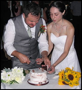 Couple cuts cake at a wedding reception