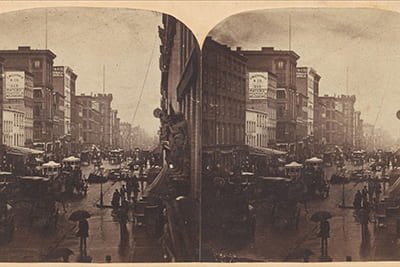Stereoscope slides show a rainy block of Broadway in New York City