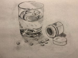 image of a glass with a bottle of pills next to it