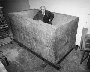 curator standing in a stone sarcophagus
