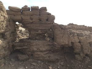 mudbrick wall over thin layers of mud deposits