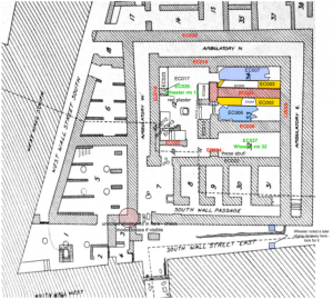 black and white plan of building with colorful notations and additions