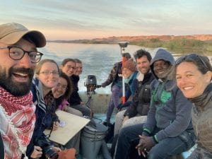 ten archaeologists in a boat on the river