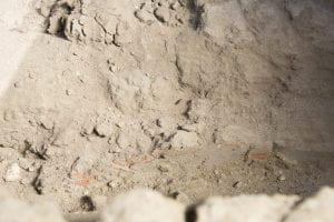 close up photo of slight traces of red paint on mud plaster